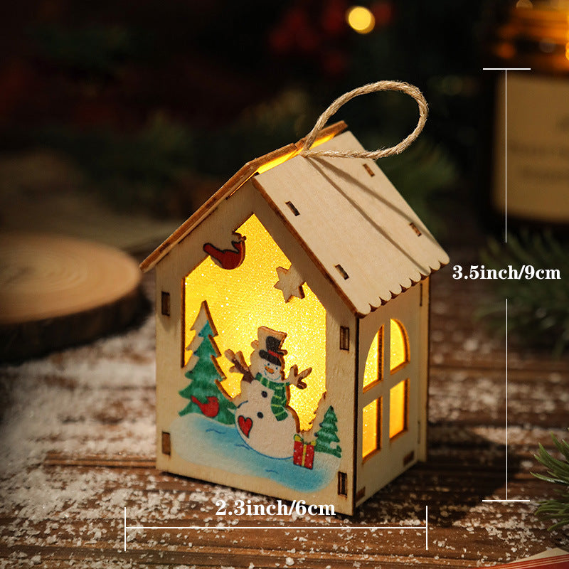 Illuminated wooden Christmas house for table decoration