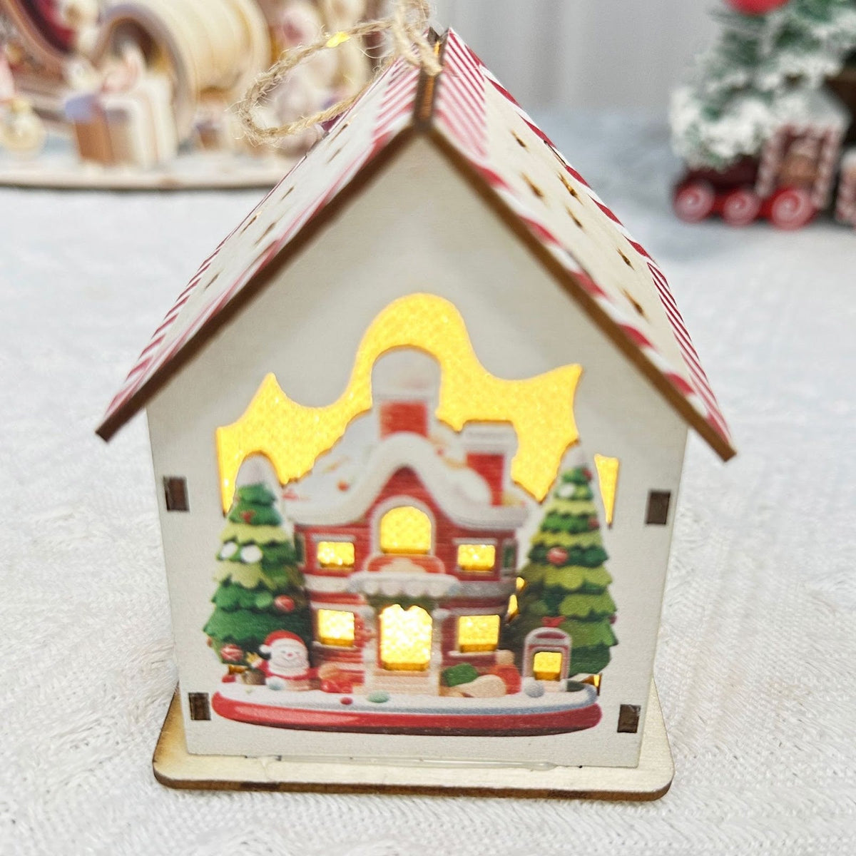 Illuminated wooden house for festive table decoration