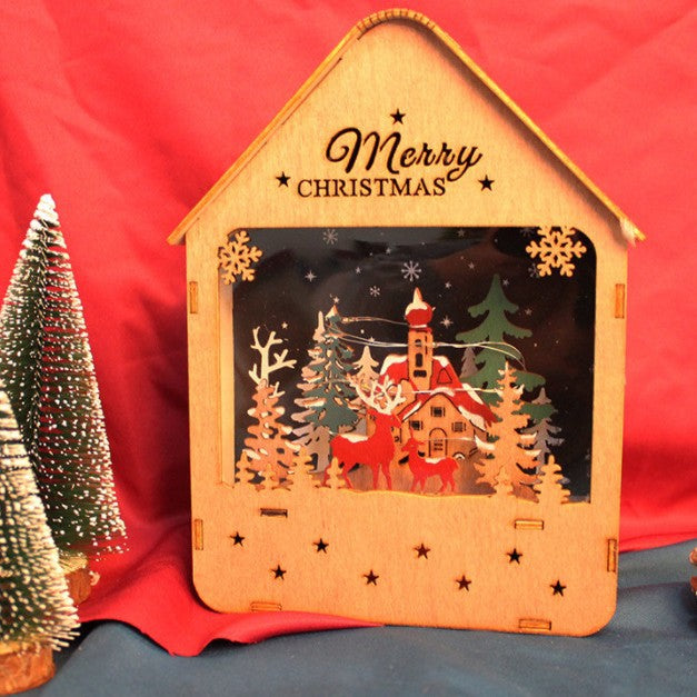 Illuminated wooden house with LED Christmas decoration