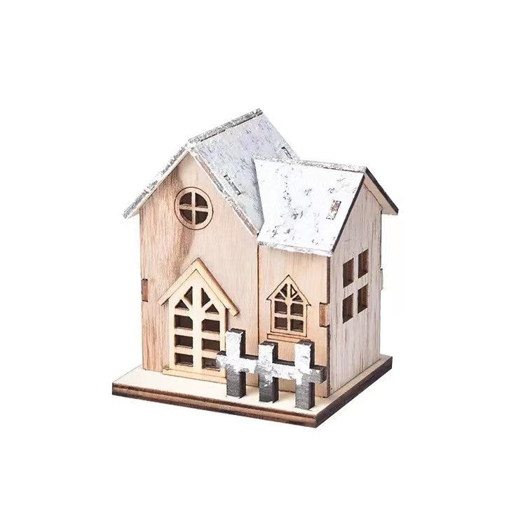 Illuminated wooden house for festive table decoration