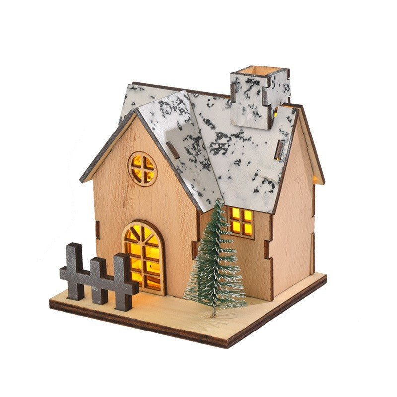 Illuminated wooden house for festive table decoration