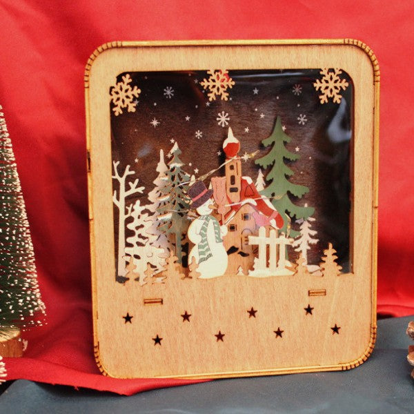 Illuminated wooden house with LED Christmas decoration