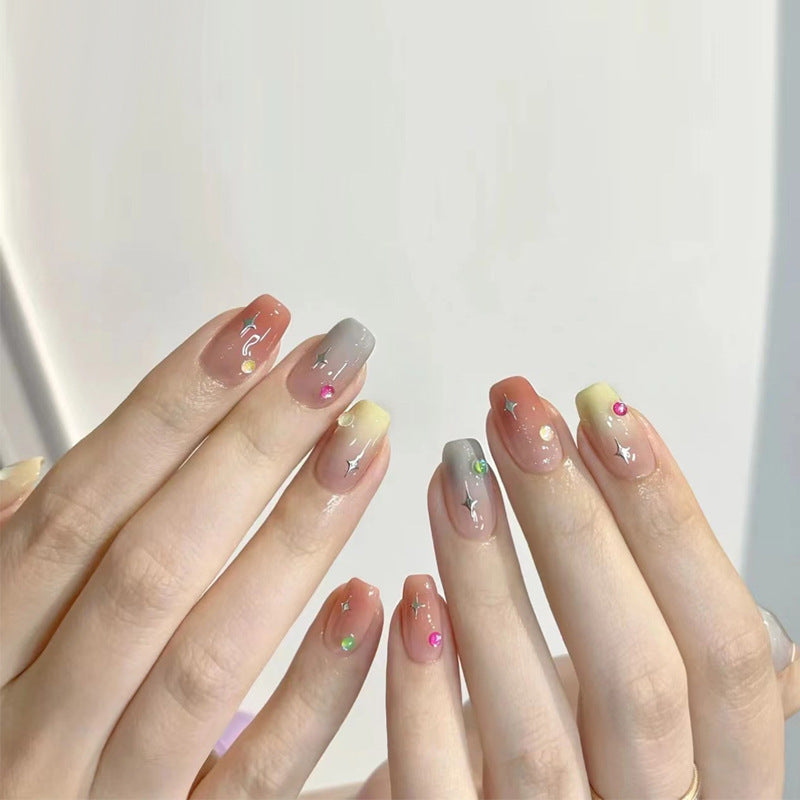 Artificial nails with heart design and glitter accents 
Maetiva