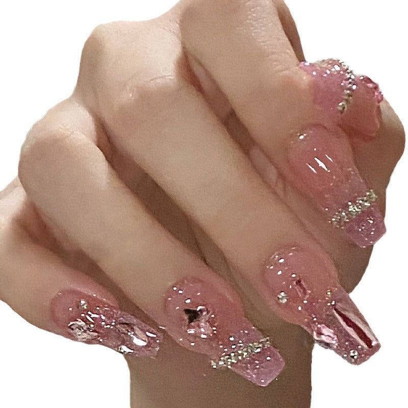 Artificial nails with heart design and glitter accents 
Maetiva