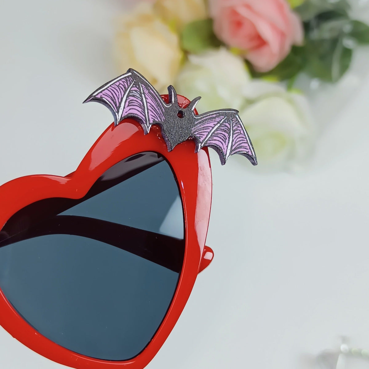 Heart-Shaped Sunglasses with Bat Accents 
Maetiva
