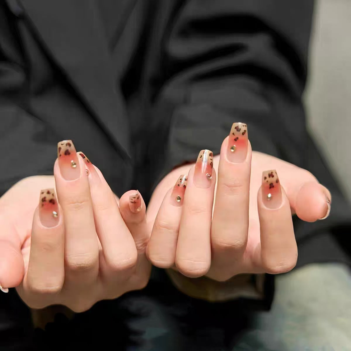 Artistic Press-On Nail Design with Floral Accents 
Maetiva