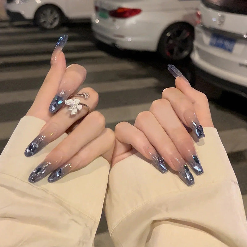 Artificial nails with heart design and glitter accents 
Maetiva
