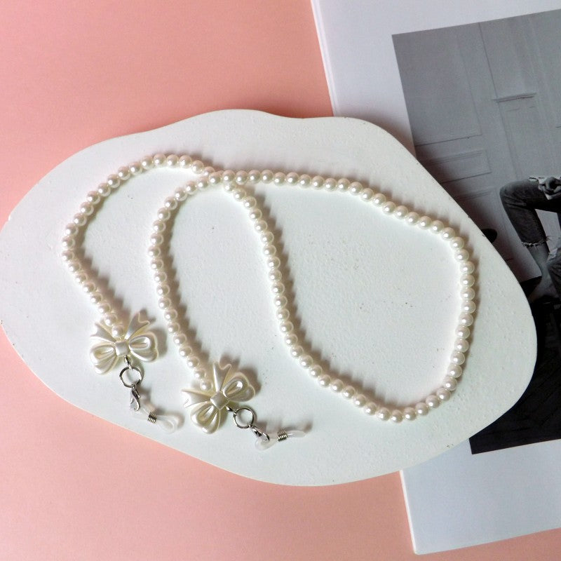 Elegant pearl glasses chain with bow pendants 
Maetiva