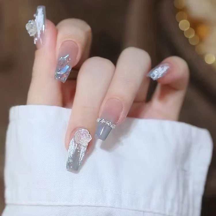 Artificial nails with heart design and glitter accents 
Maetiva