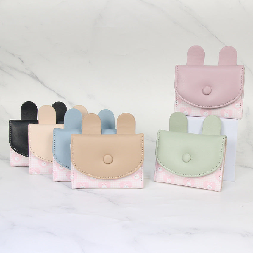 Compact rabbit-themed coin purse with snap closure and card slots 
Maetiva