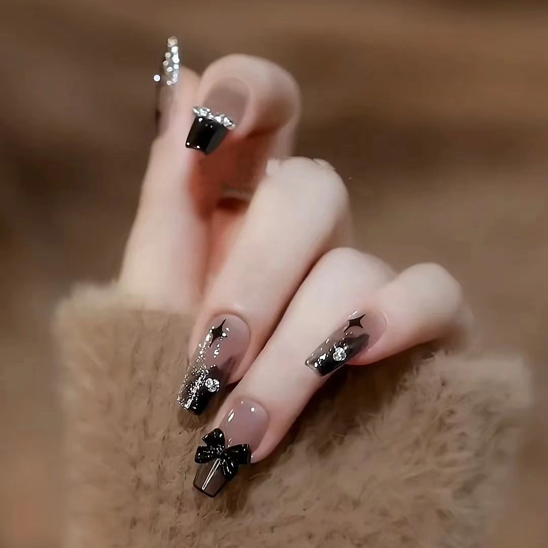 Artificial nails with heart design and glitter accents 
Maetiva