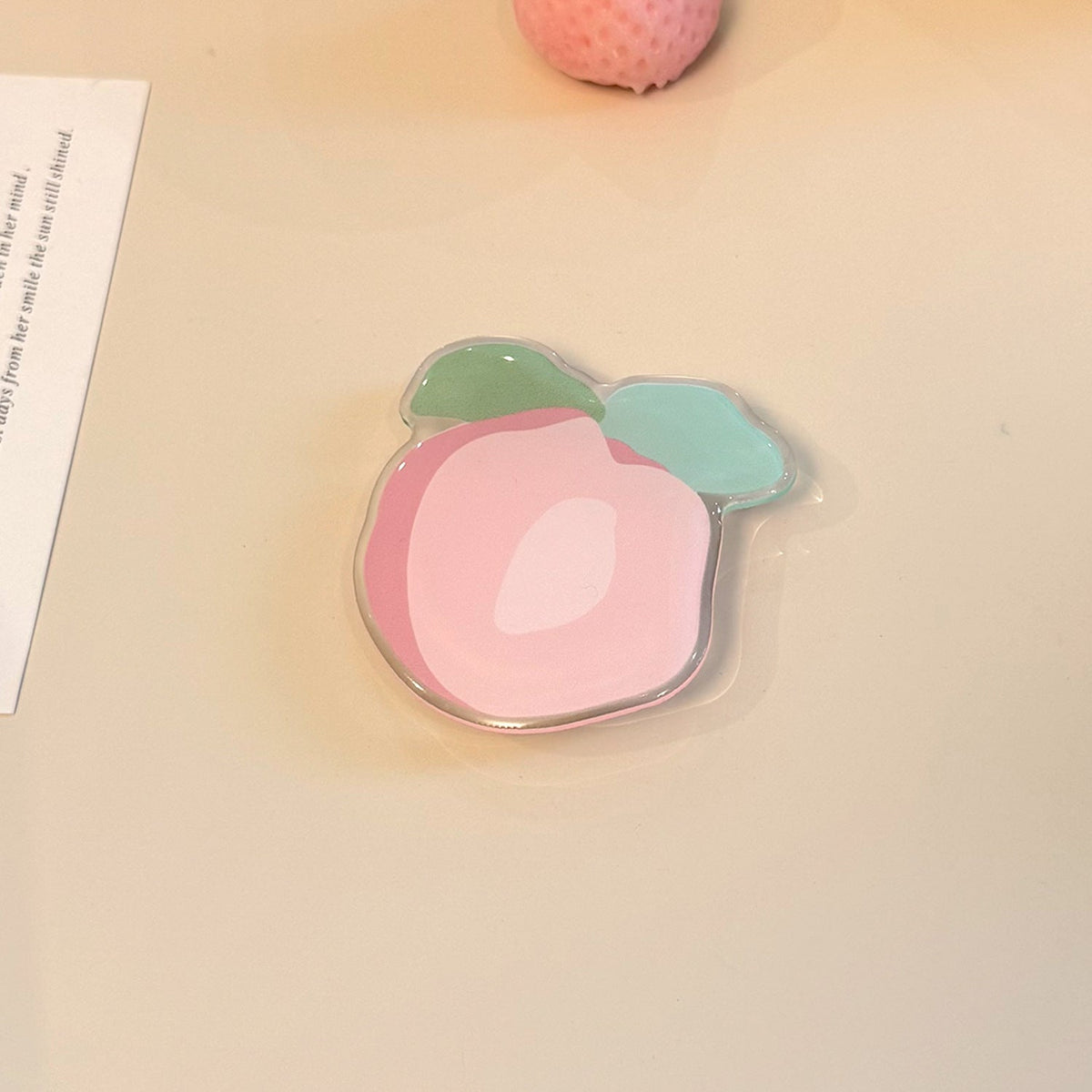 Original coaster in peach-shaped design 
Maetiva