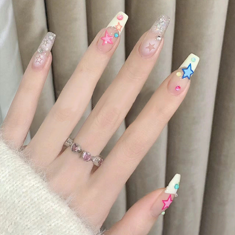 Artificial nails with heart design and glitter accents 
Maetiva