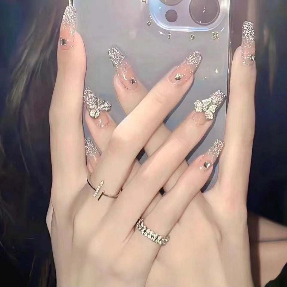 Artificial nails with heart design and glitter accents 
Maetiva