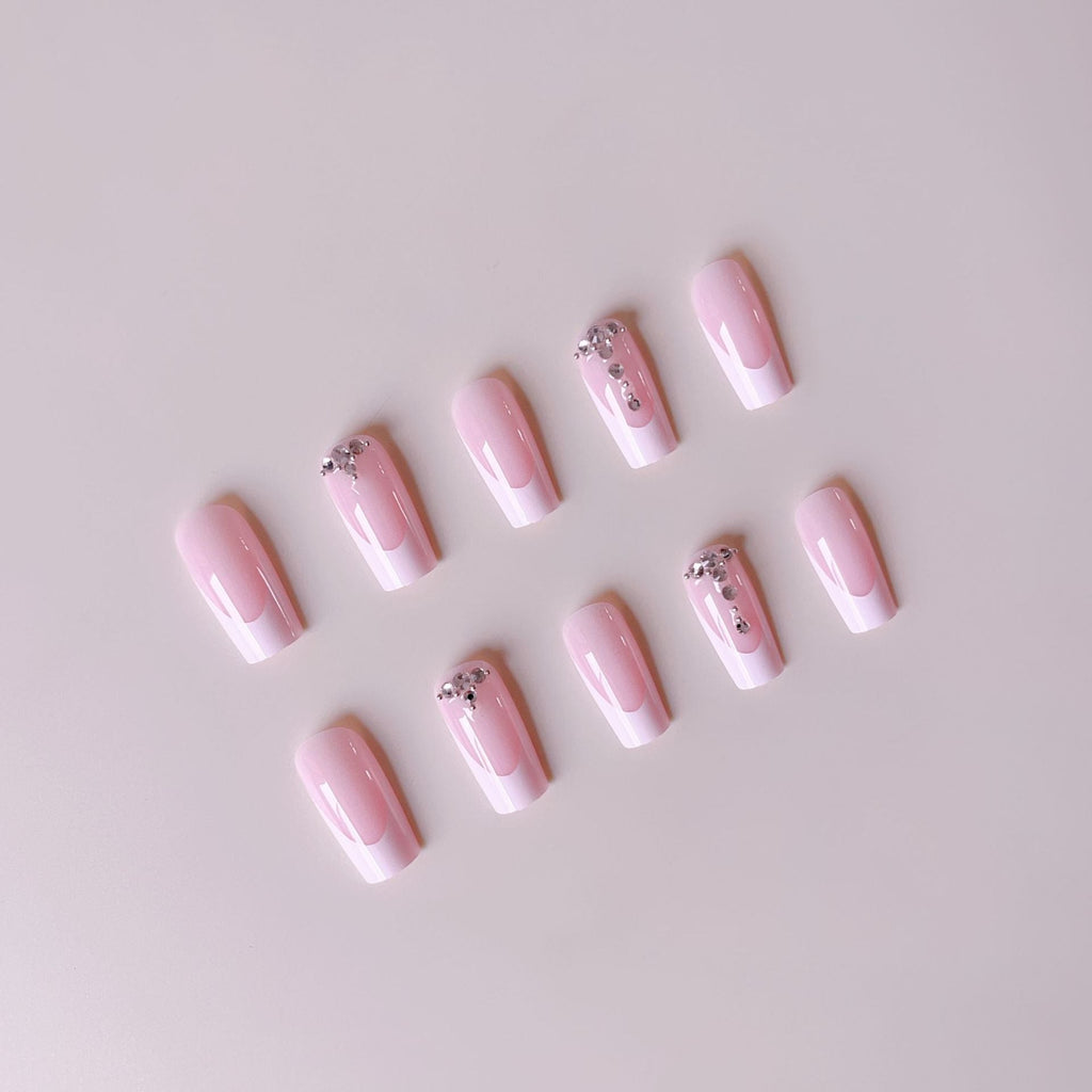 Acrylic nail set with elegant French tips and sparkling rhinestone accents 
Maetiva