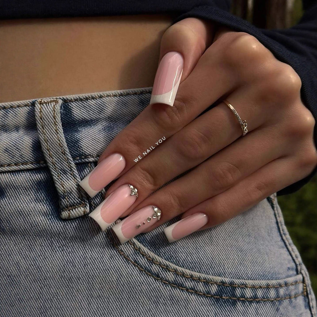 Acrylic nail set with elegant French tips and sparkling rhinestone accents 
Maetiva