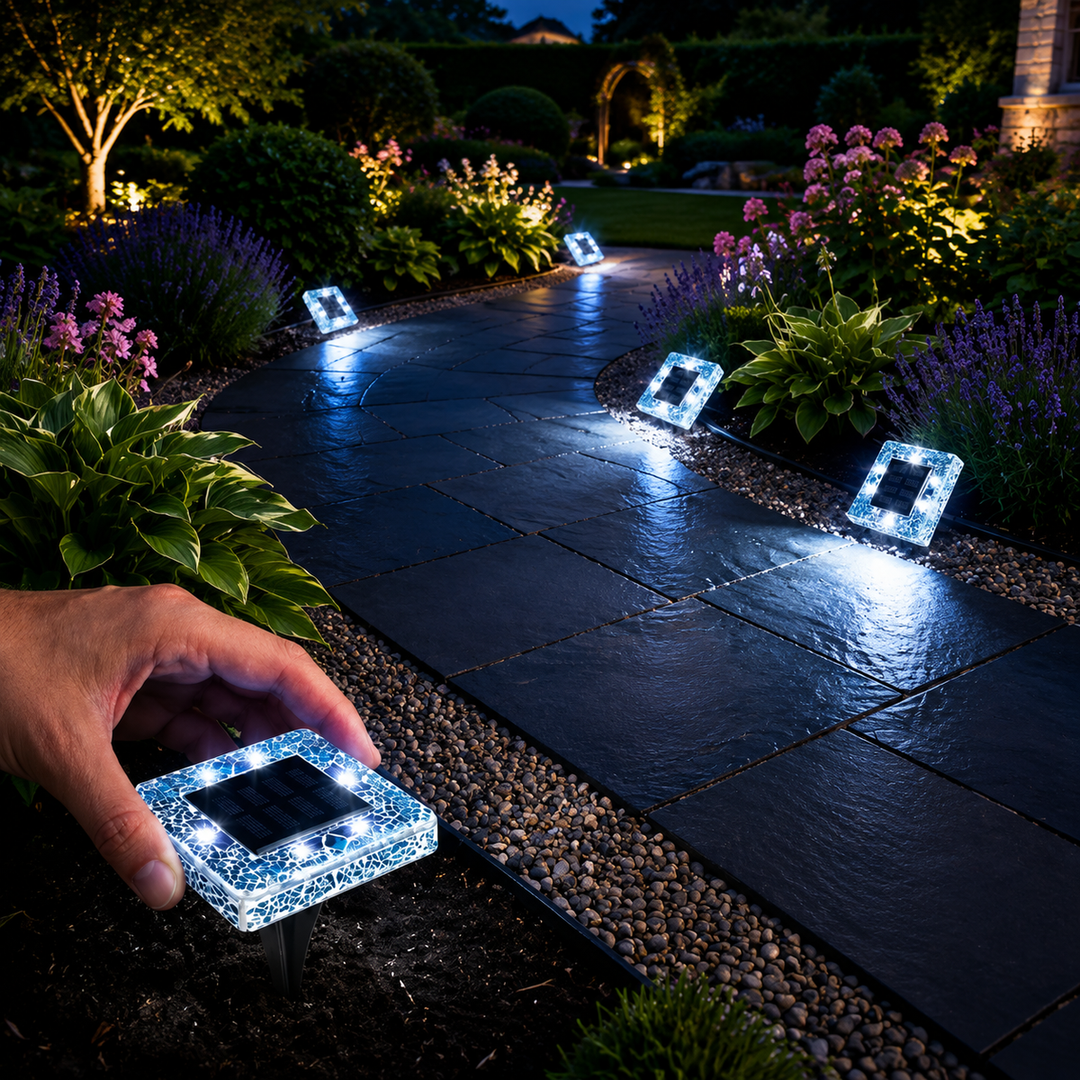 Solar ground lights installed along a garden pathway at night